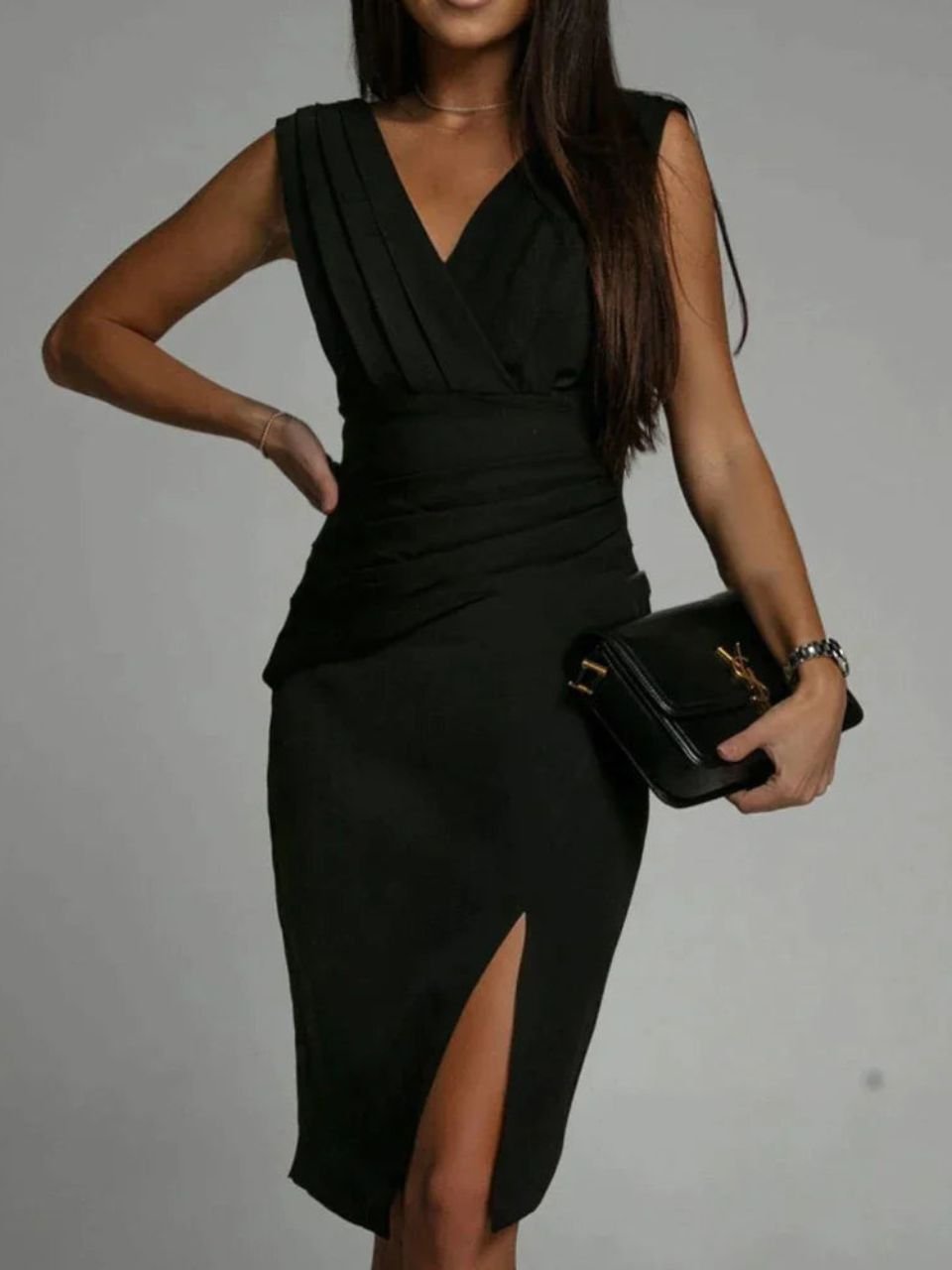Woman showcasing a refined evening dress with a plain backdrop.