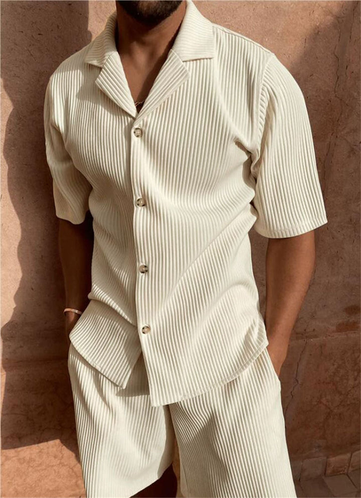 Male model wearing a ribbed short sleeve button-front shirt with matching shorts on a plain background.