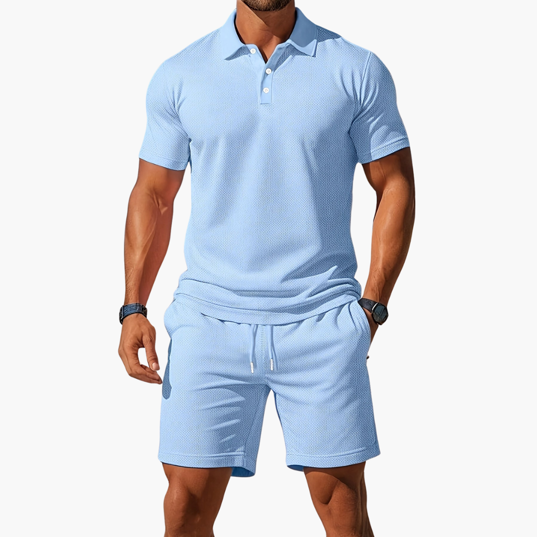 A model wears a casual polo two piece set with drawstring shorts against a plain background.