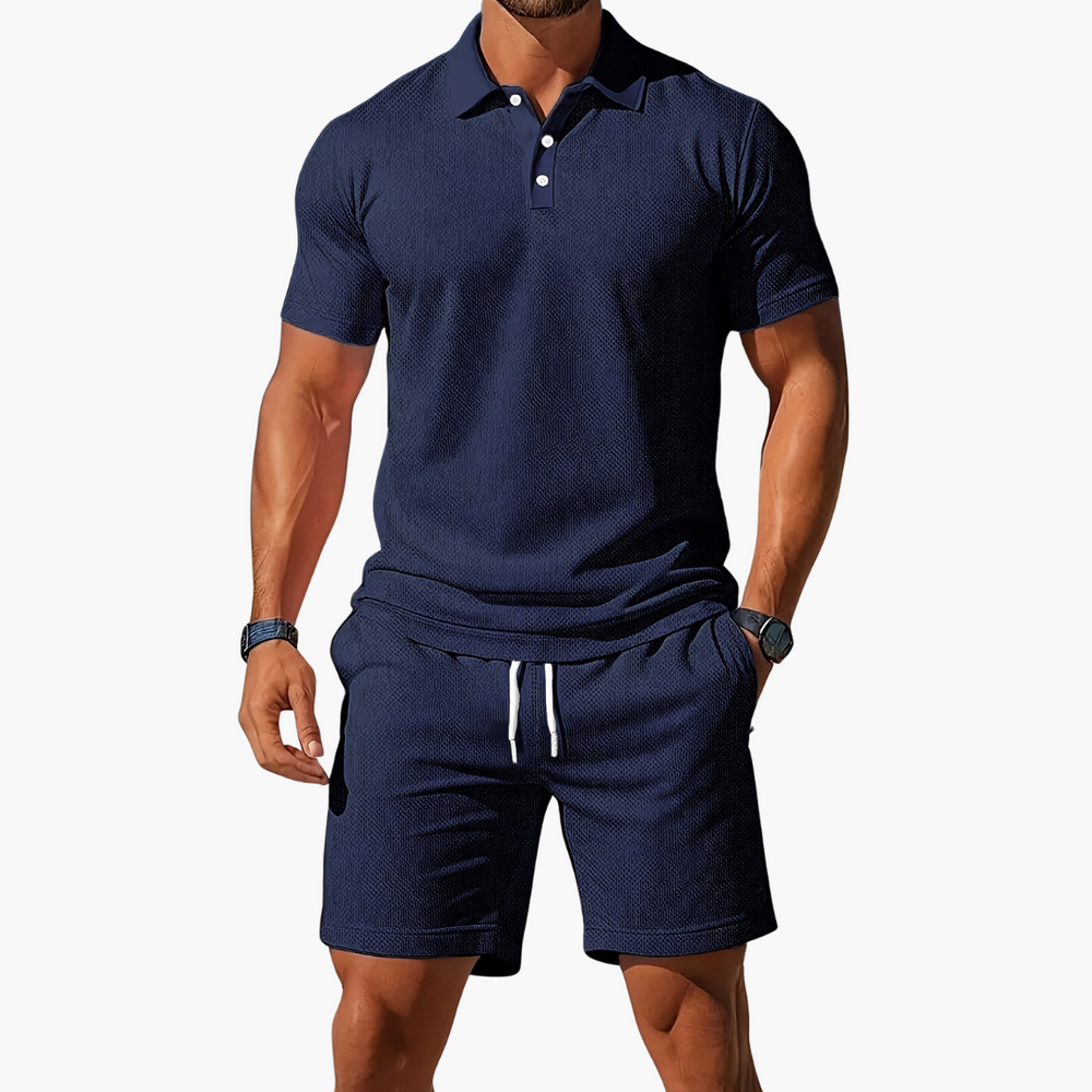  A model shows a matching short sleeve polo top and drawstring shorts on a plain background.