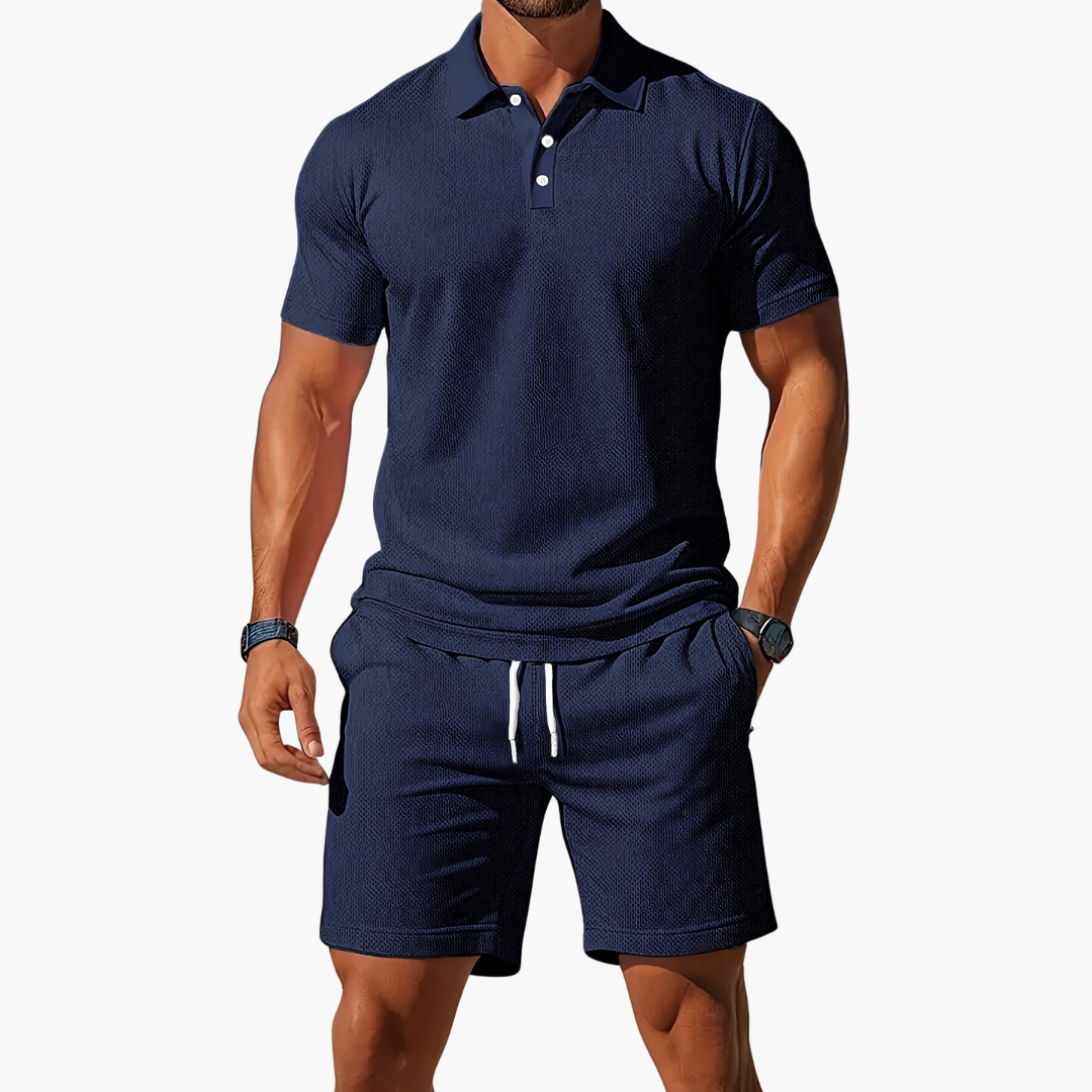  A model shows a matching short sleeve polo top and drawstring shorts on a plain background.
