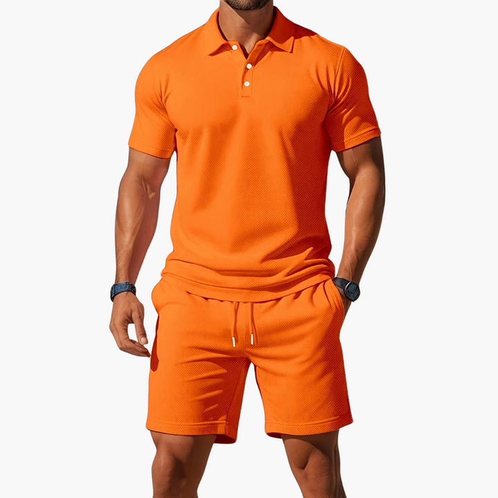  A model stands in a coordinated polo shirt and shorts set against a plain background.