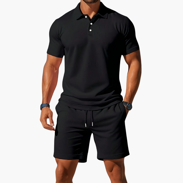 A model shows a clean collared two piece set with coordinated shorts against a plain background.