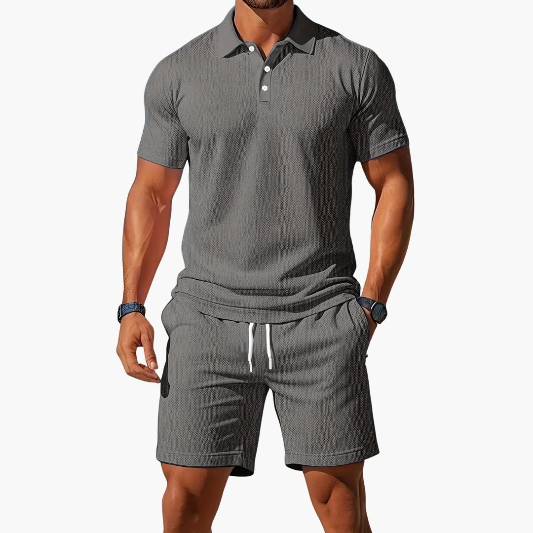  A model wears a button front polo top and matching shorts on a plain background.