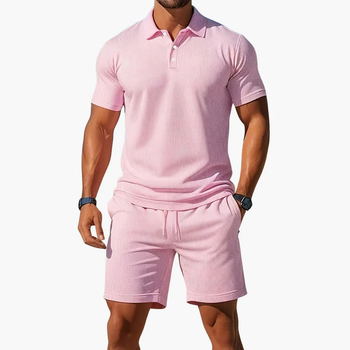 A model wears a button front polo top and matching shorts on a plain background.