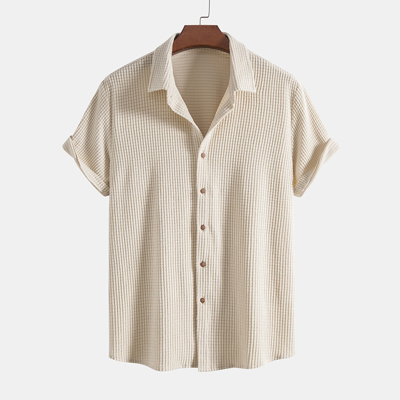 A coordinated short sleeve shirt and matching shorts outfit on a plain background.