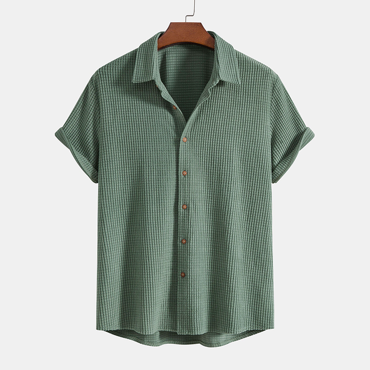 A matching short sleeve shirt and drawstring shorts set displayed on a plain background.
