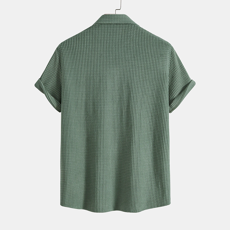 A relaxed short sleeve shirt paired with coordinating shorts on a plain background.

