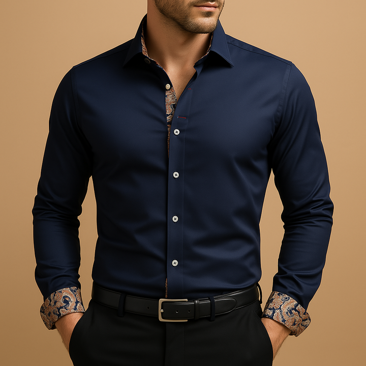 A smart-casual button-up shirt with patterned cuff accents against a plain background.
