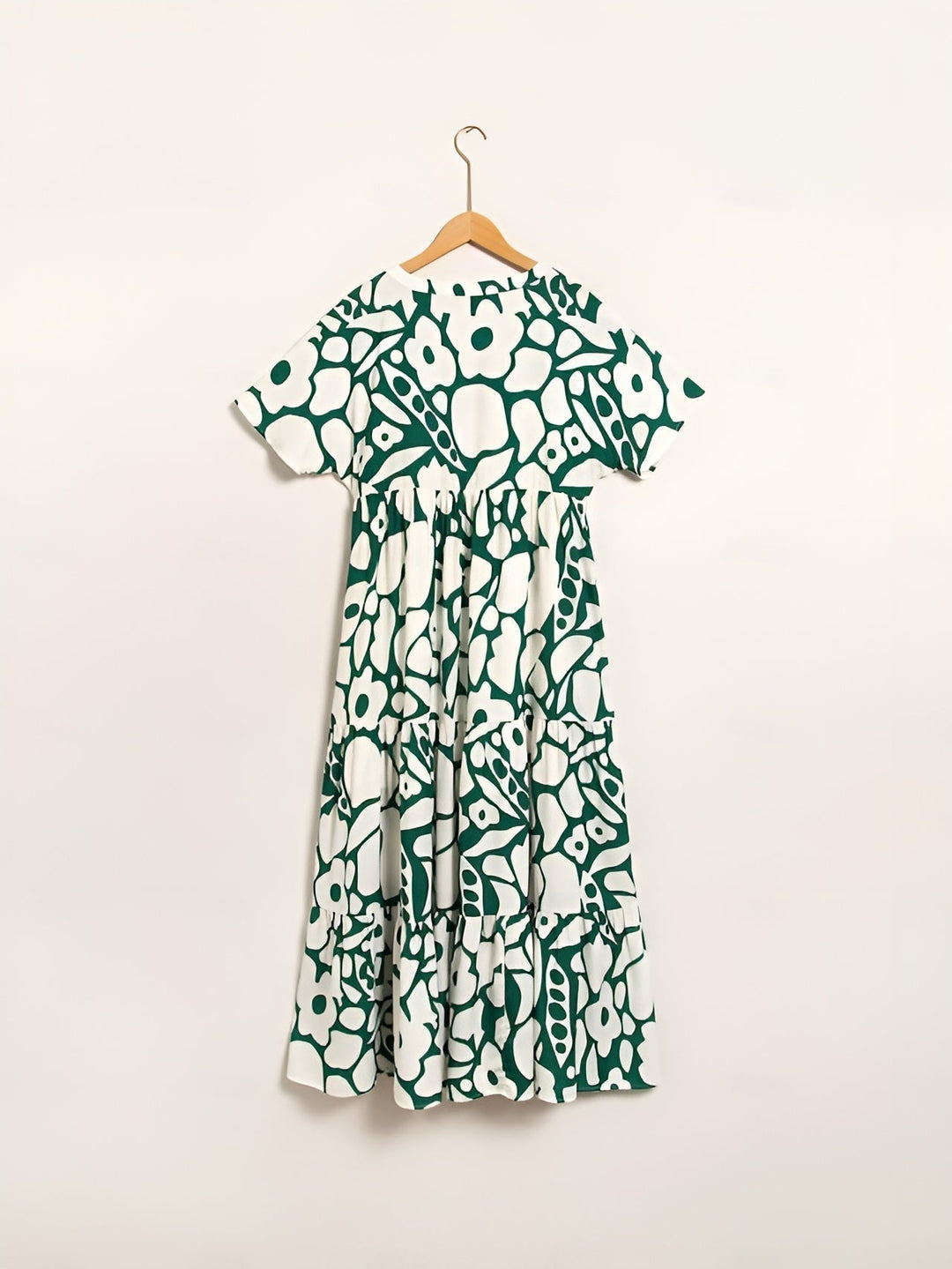 Airy feminine dress styled on a clean background, back angle view detail