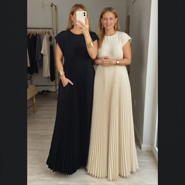 Airy pleated maxi dress styled with a graceful silhouette on a woman.