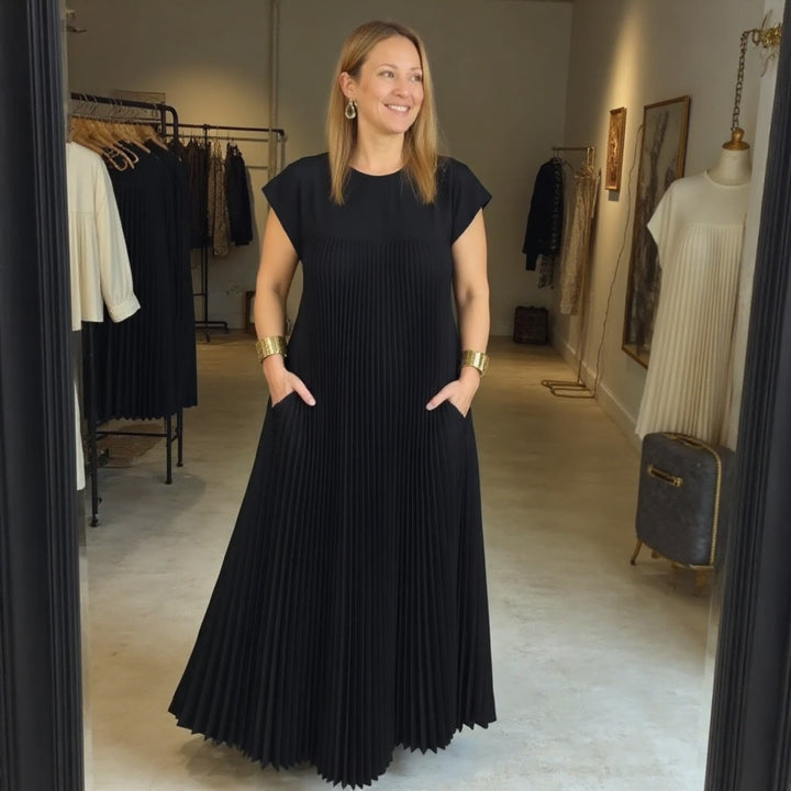 Cocktail maxi dress with a defined waist displayed on a plain background.