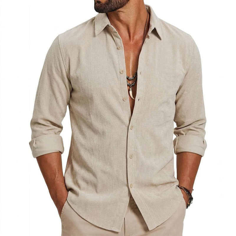  Male model dressed in a navy button-front shirt with long sleeves and contrast trim against a plain background.