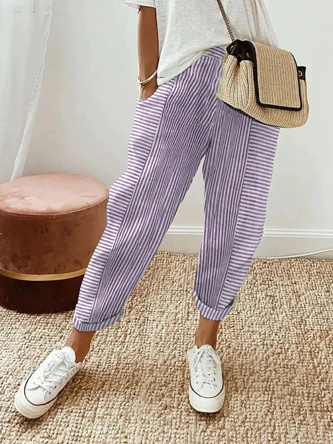 Model wearing high-waist striped pants against a plain background.