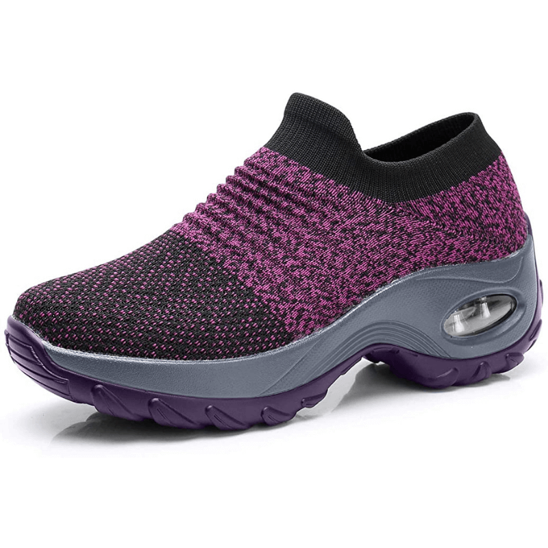 Comfortable women’s shoes displayed on feet with a minimal plain background.