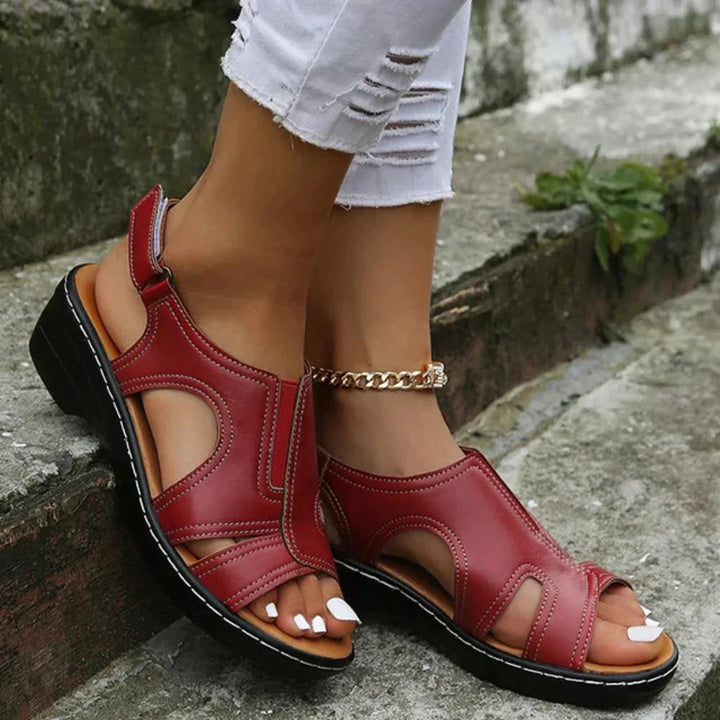 Foot shown wearing comfortable walking sandal with adjustable strap.