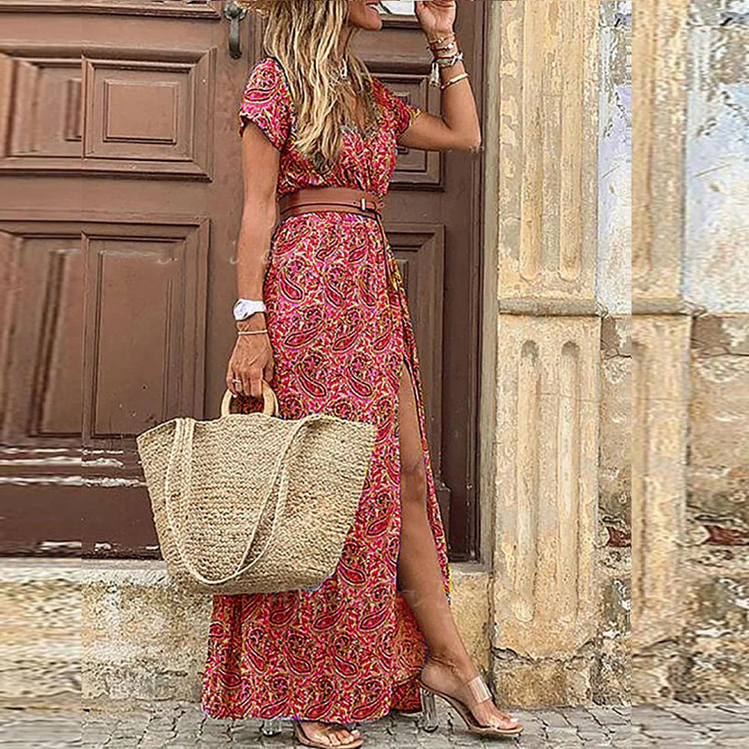 Woman wearing a boho-inspired printed maxi dress with adjustable waist belt on a neutral background.