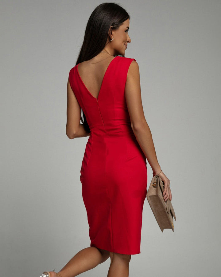Woman posing in a fitted sleeveless dress featuring a deep V-neck and sleek silhouette.