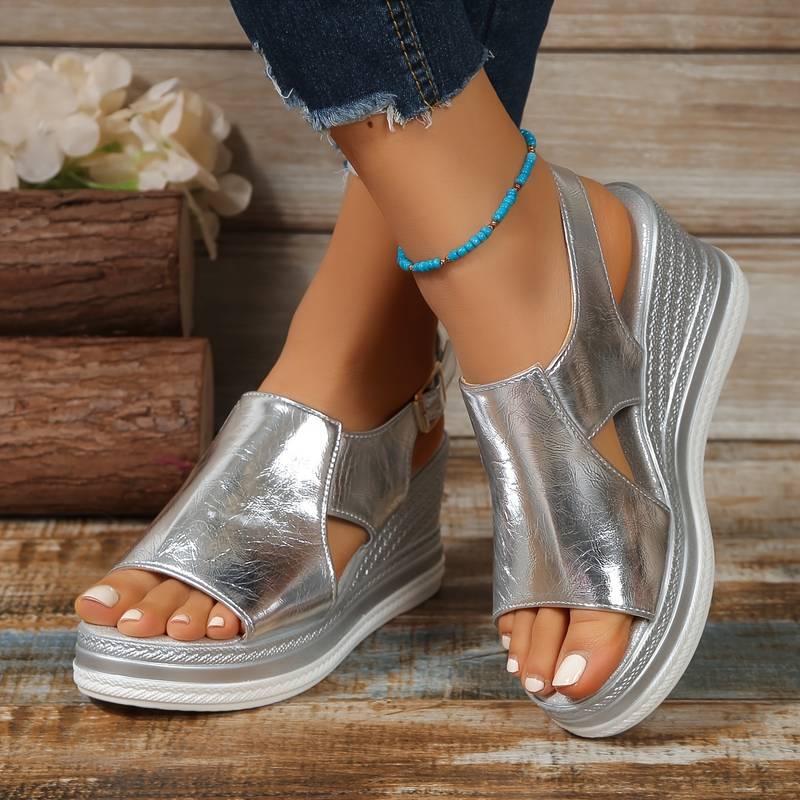 Female feet wearing orthopedic sandals on a clean background.