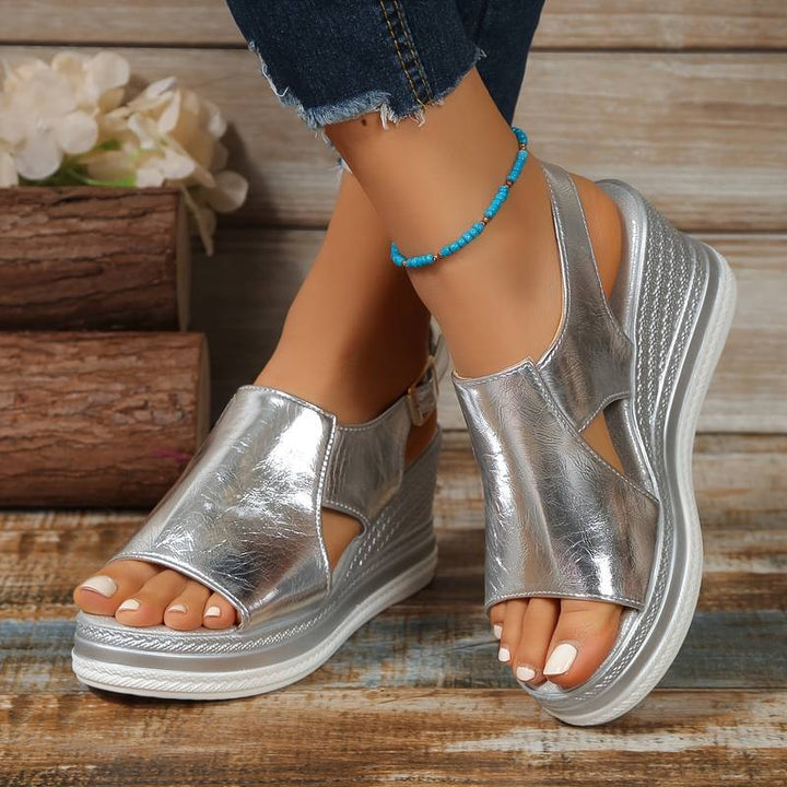Female feet wearing orthopedic sandals on a clean background.