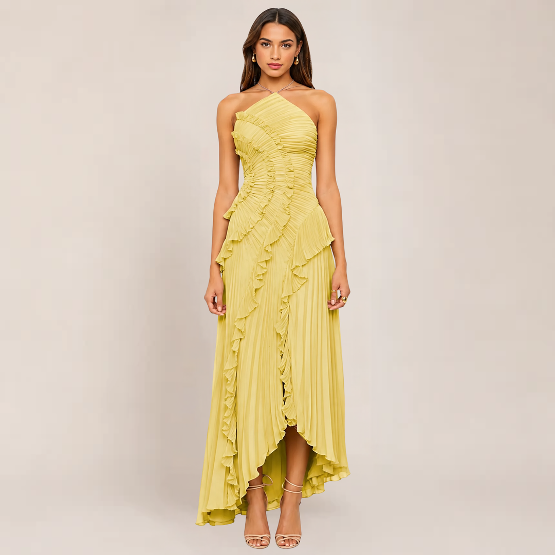 Woman in a sleeveless halter dress with ruffle neckline on a plain background.