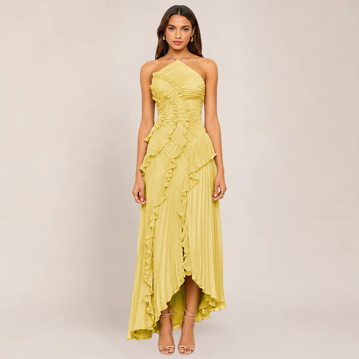 Woman in a sleeveless halter dress with ruffle neckline on a plain background.