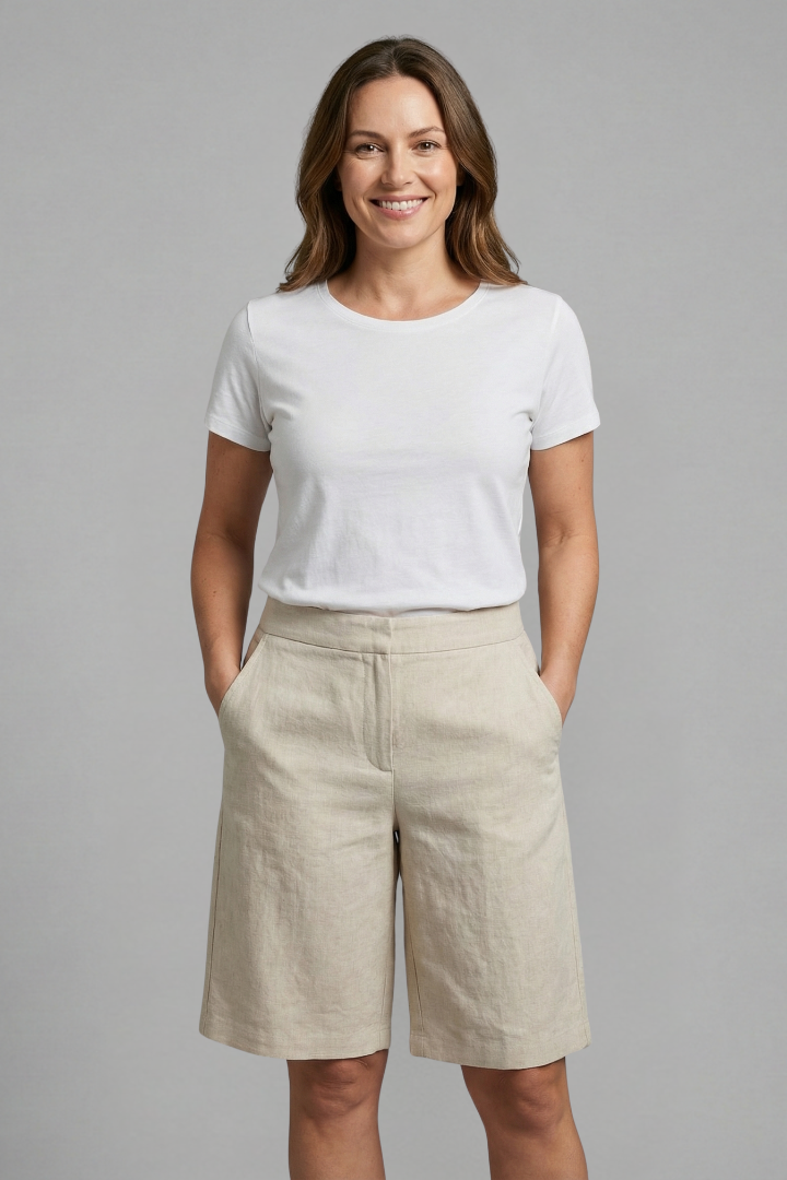 Female model wearing elastic waist knee length shorts against a plain background.