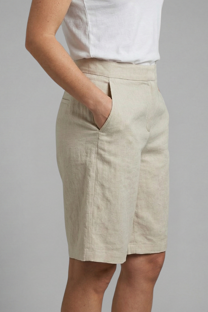 Female model showcasing casual elastic waist shorts in a studio setting.