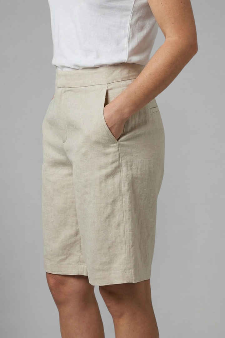 Female model standing in lightweight summer shorts with side pockets.