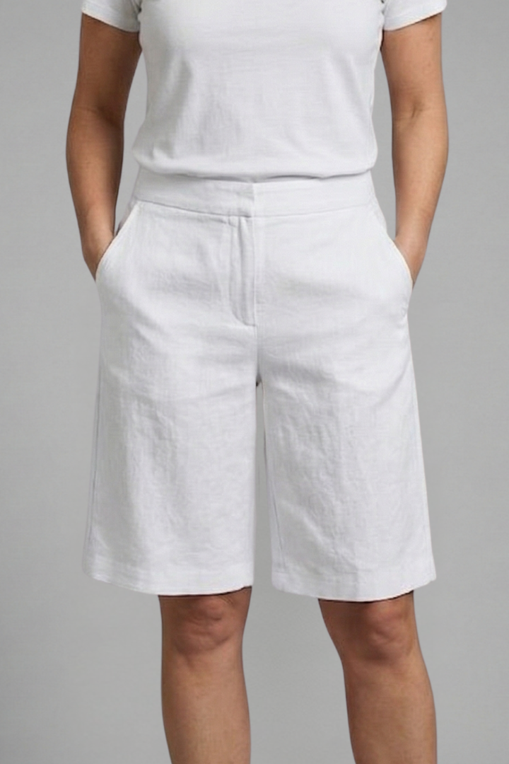 Woman styling elastic waist casual shorts against a clean studio background.