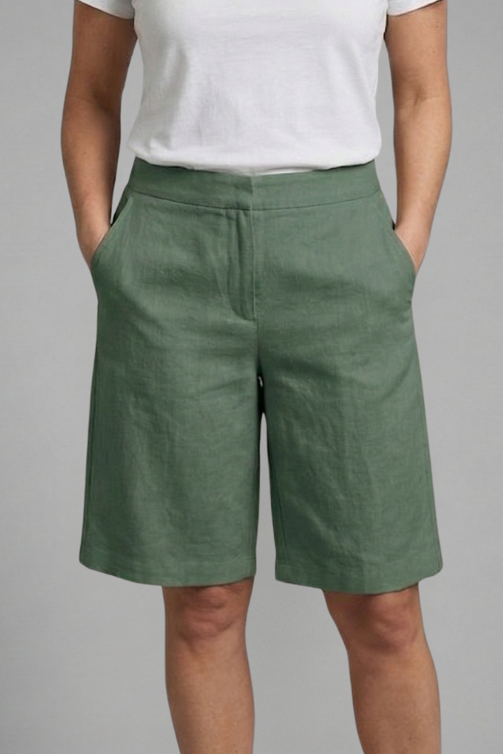 Female model wearing knee length shorts with an easy relaxed fit.
