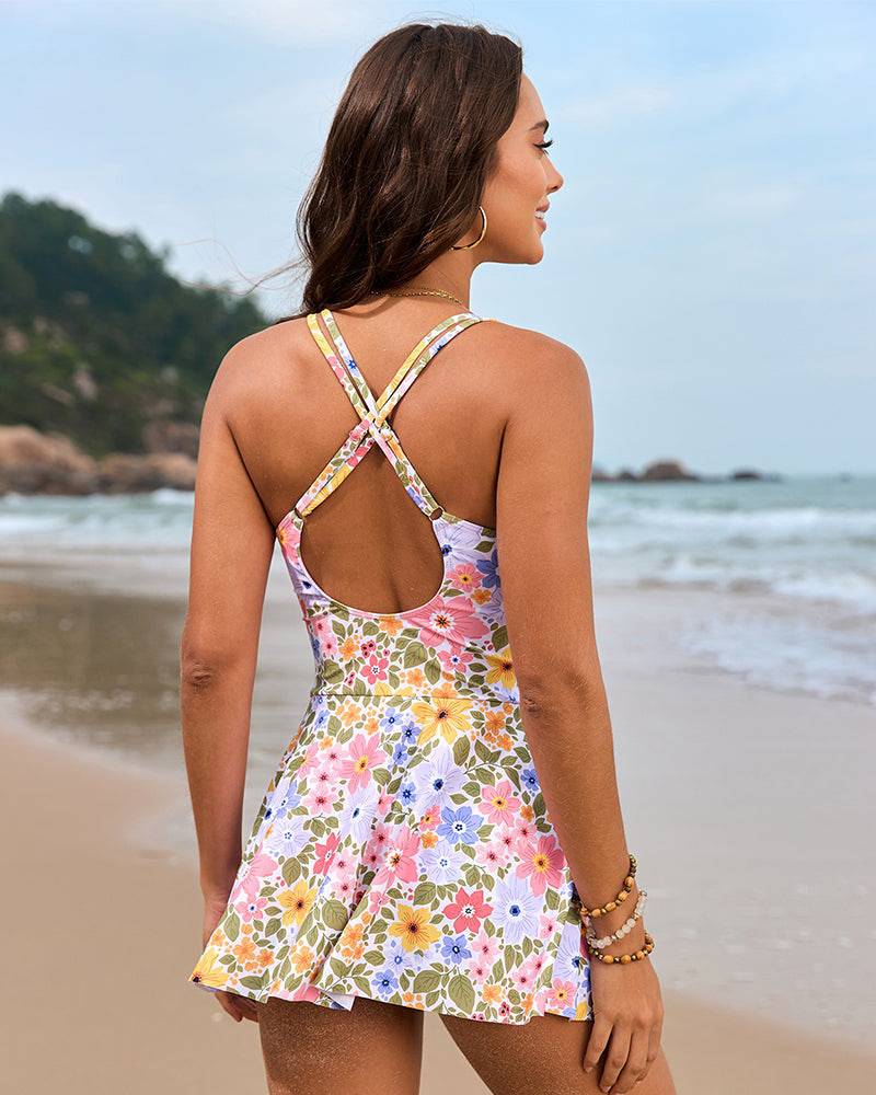 Woman wearing a swim dress designed for poolside and vacation styling on a plain background.