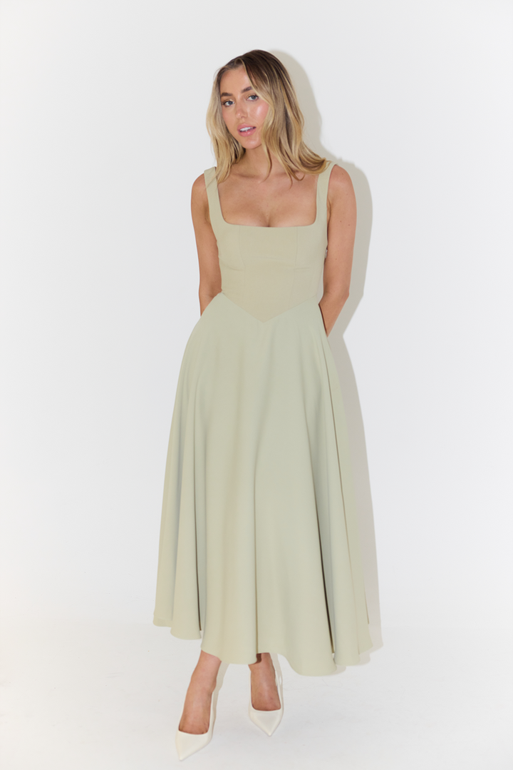 Female in a polished sleeveless satin dress suitable for special occasions on a clean background.