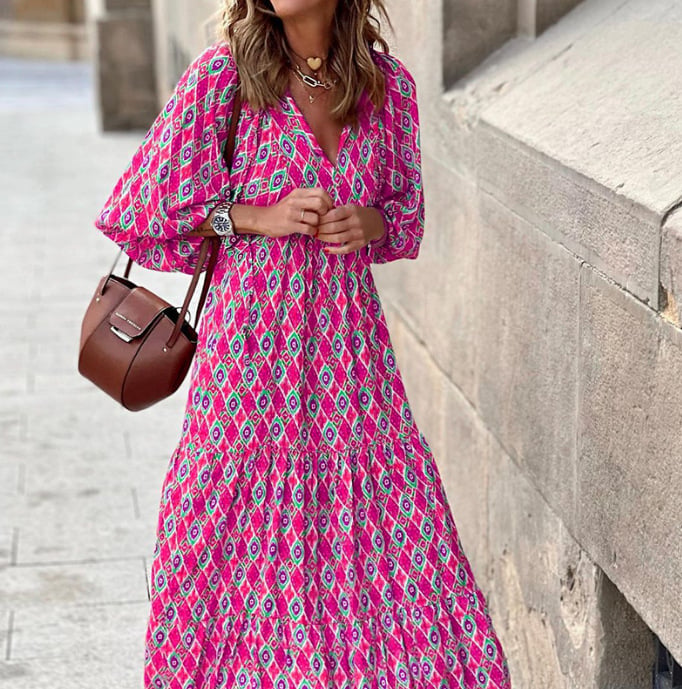 Printed ankle-length dress with tie front detail displayed on a woman against a plain background.