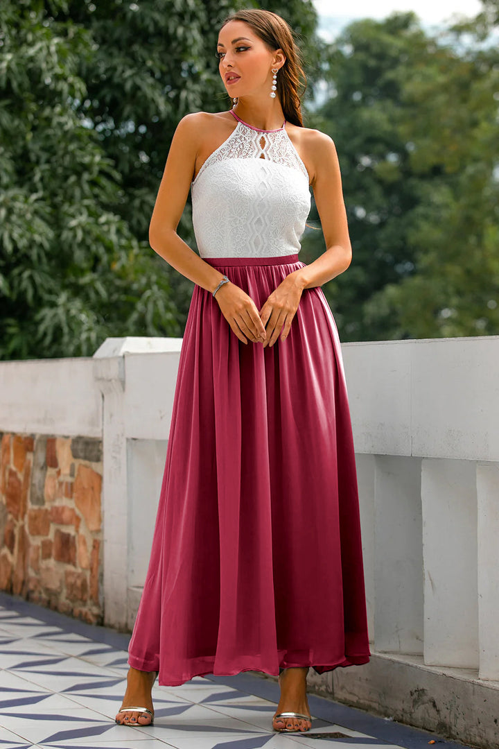 Woman wearing graceful evening dress surrounded by natural greenery.