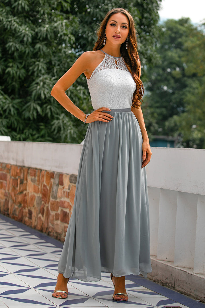 Female model in sleeveless occasion dress on sunny terrace.