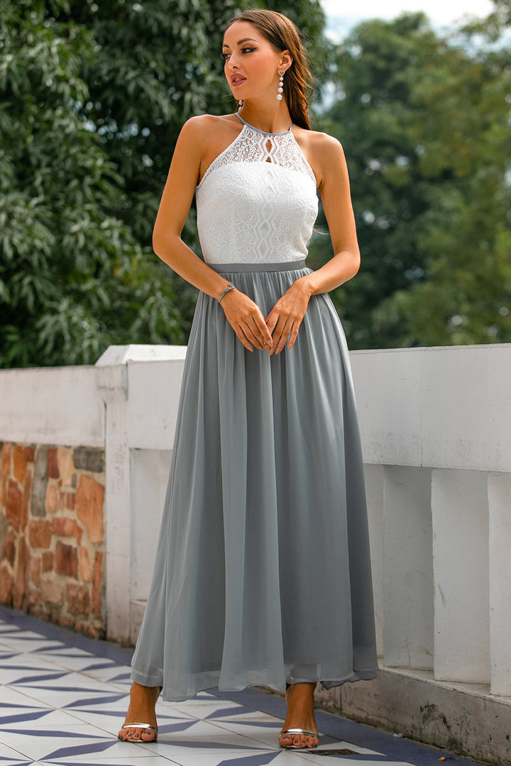 Female model posing in long formal dress with nature background.