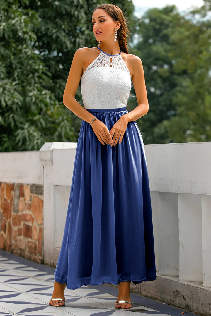 Woman posing in elegant long dress beside terrace railing.