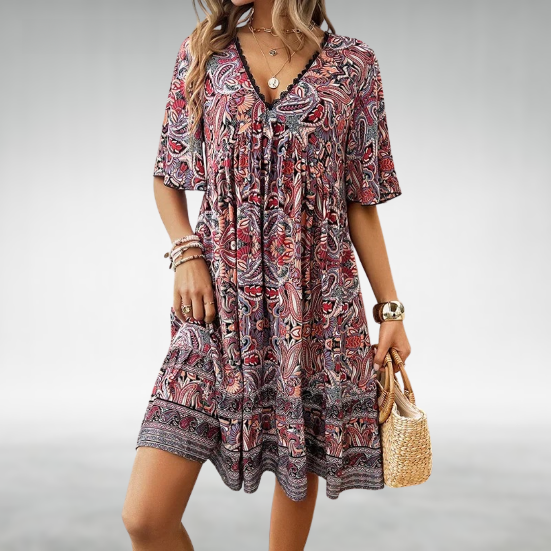 Boho style mini dress with V neckline displayed on a female model against a plain background