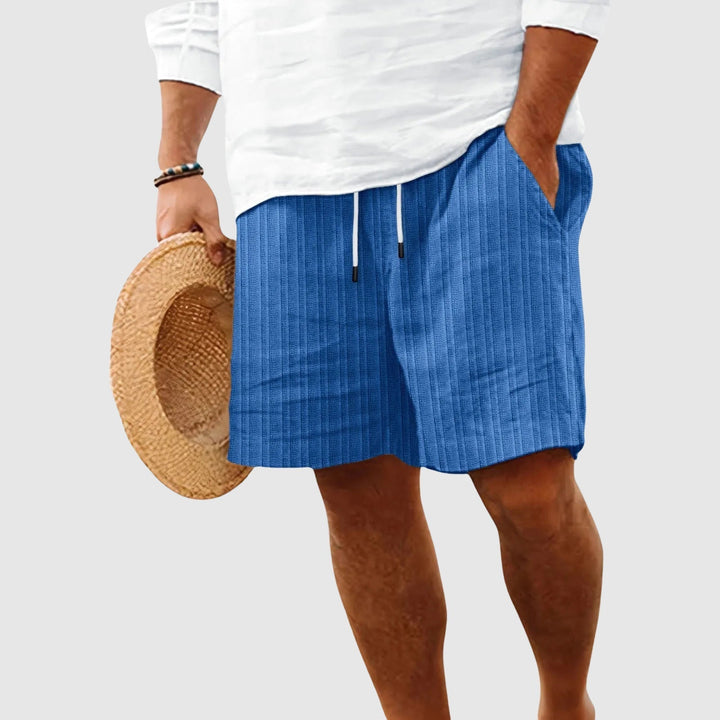 Male model wearing soft-look drawstring shorts with a clean casual style on a plain background.