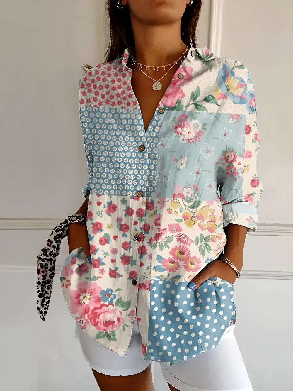 Chic patterned blouse w/ model on a plain background for polished everyday outfits.