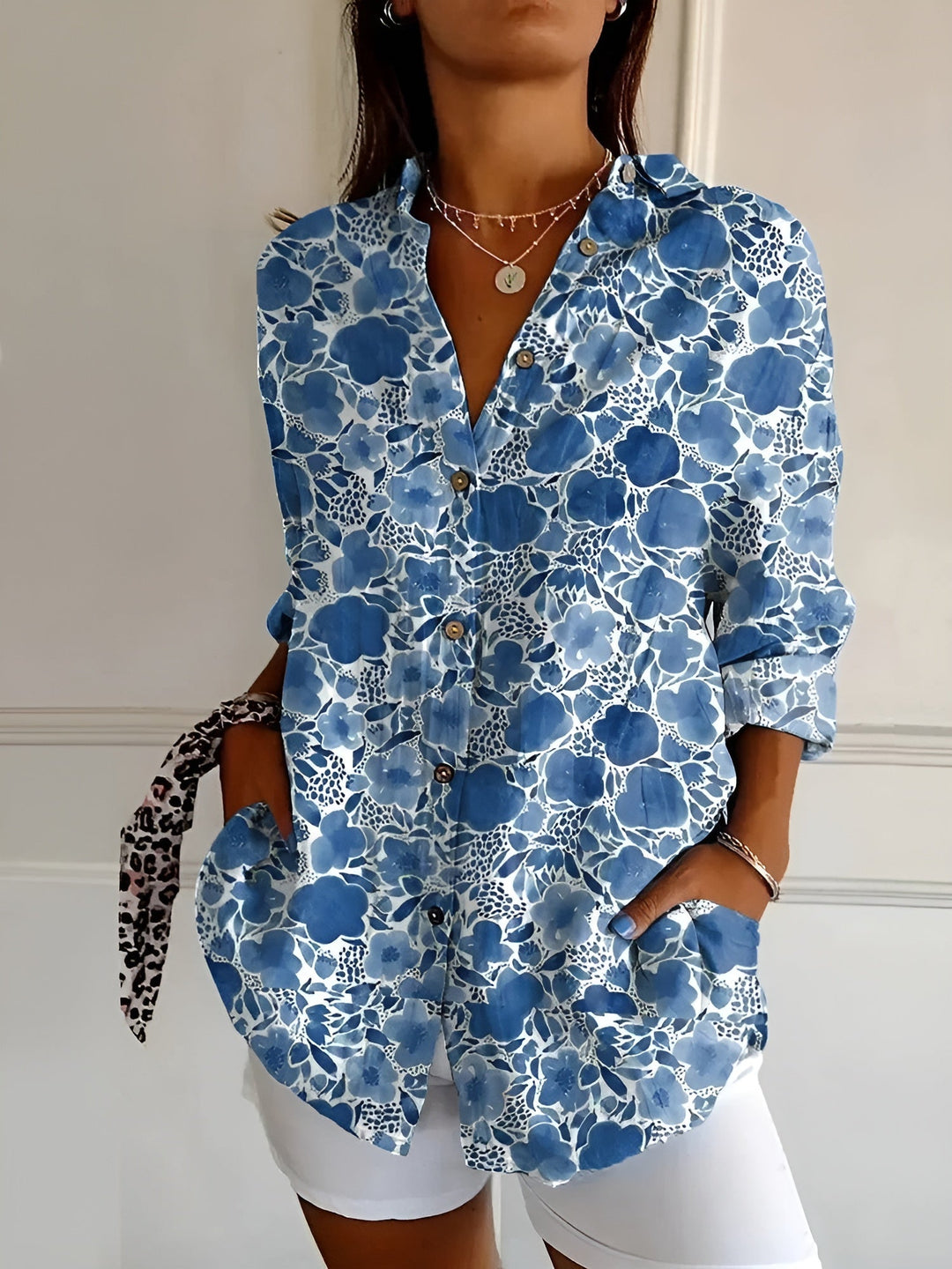 Women’s breathable blouse w/ model on a plain background for effortless daily wear.