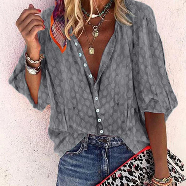 Front folded blouse showcasing soft texture on plain backdrop