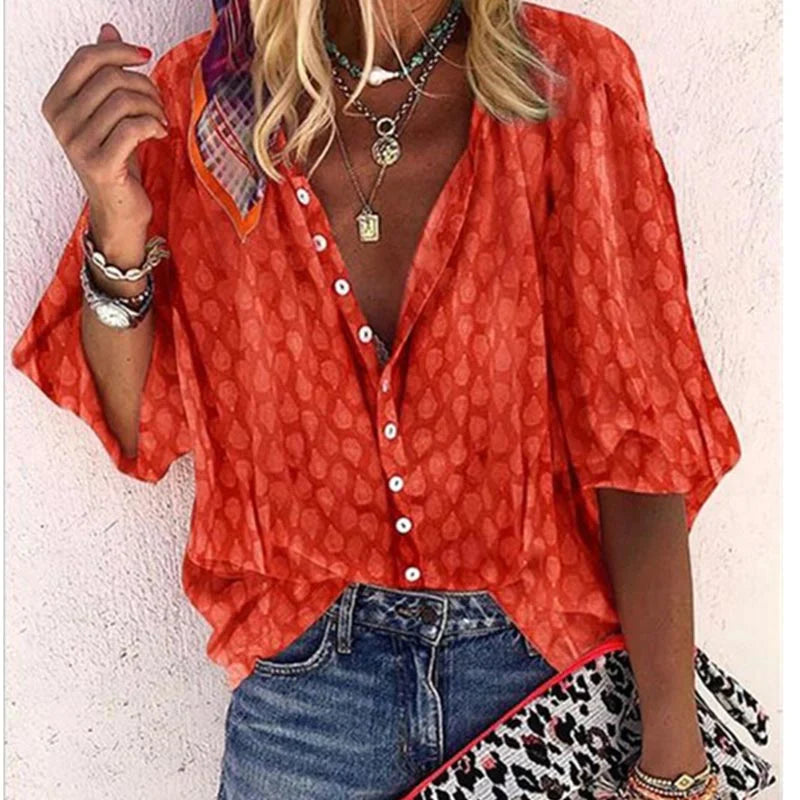 Folded blouse stack displayed on minimal plain background