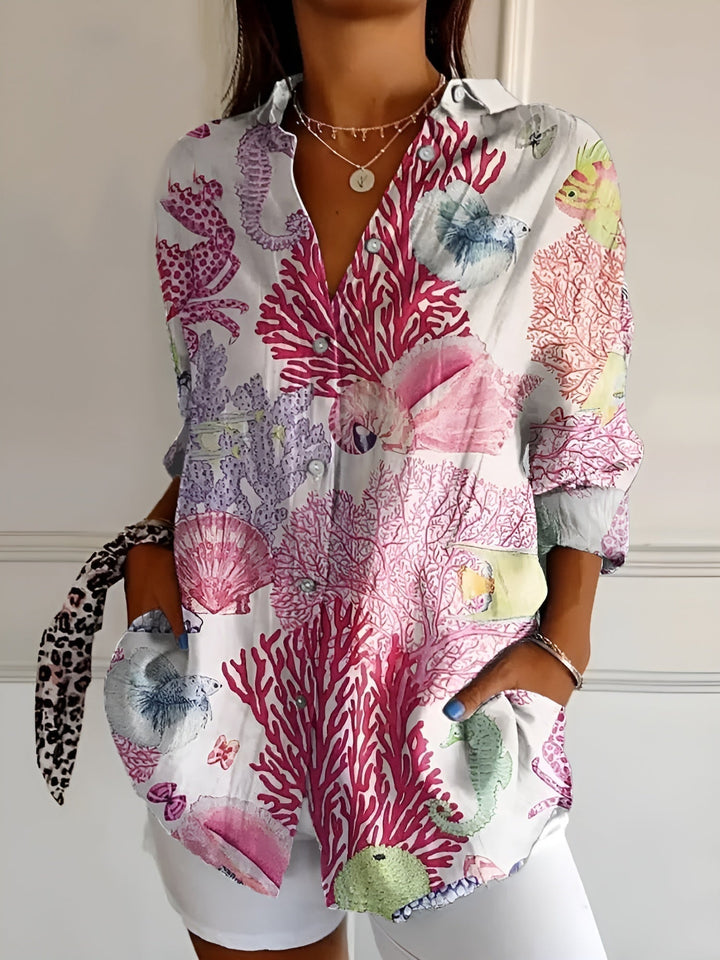 Women’s artistic print blouse w/ model on a clean background with relaxed styling.