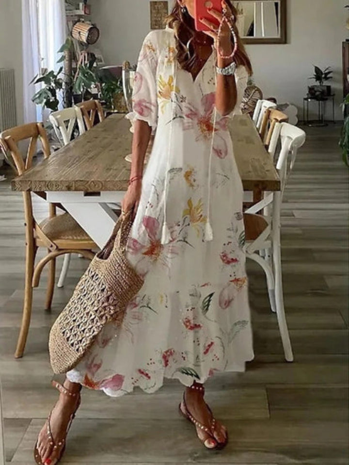 A boho V-neck maxi dress with artistic prints and graceful drape.