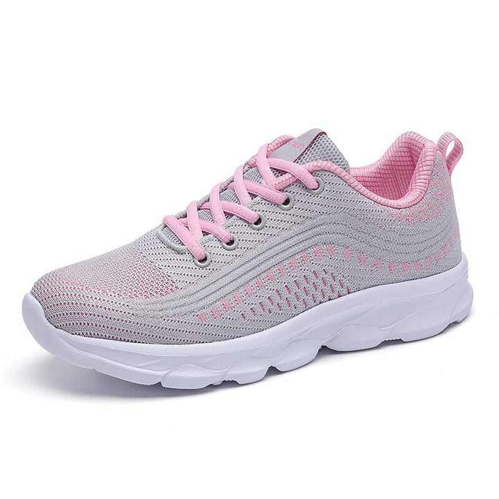 Side view of women’s cushioned casual shoes displayed on a plain background.