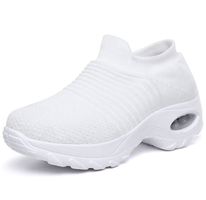 Stylish women’s comfort shoes shown on female feet against a plain background.