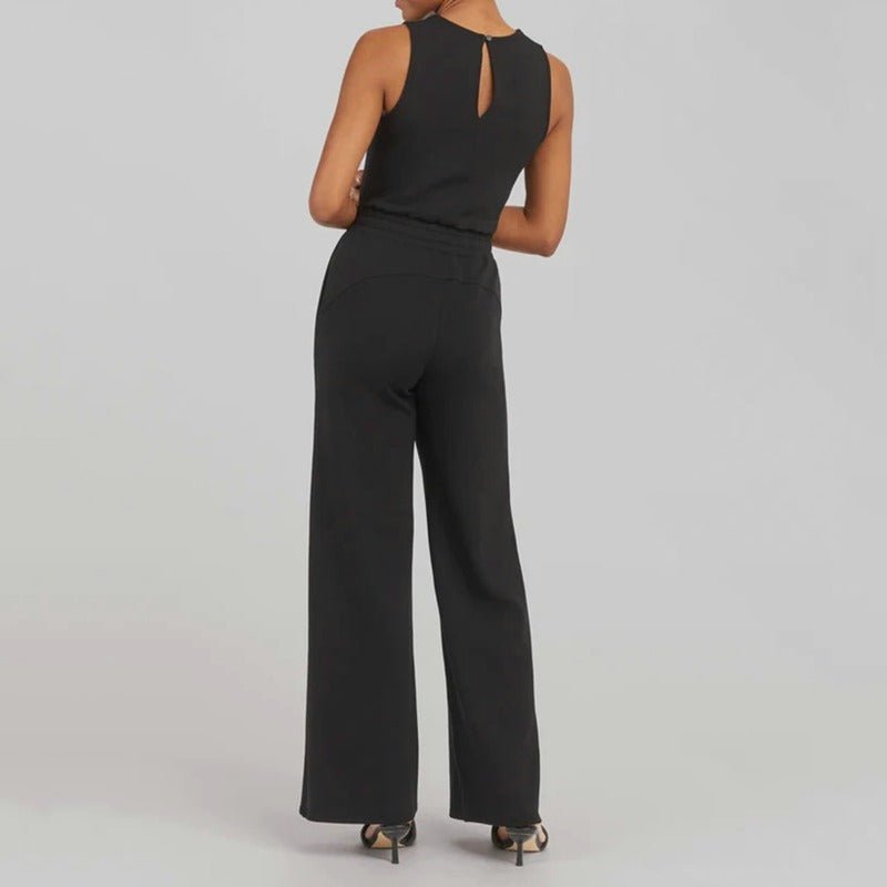 Women’s event-ready jumpsuit shown with a sleek waist detail on a plain background, back view