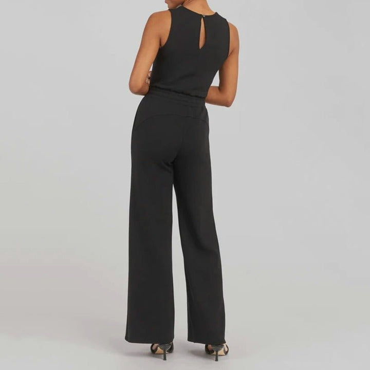 Women’s event-ready jumpsuit shown with a sleek waist detail on a plain background, back view
